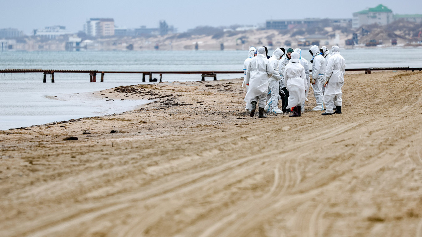 The workers cleaning up shore of the Black Sea after oil spill